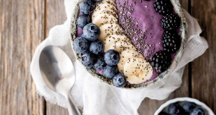 Bowl of soya yoghurt, blackberries and blueberries