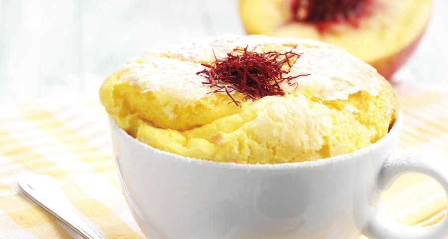 Vanilla soufflé on a bed of saffron-infused peaches