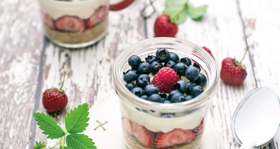 Cheesecake in a jar with blueberries, raspberries and strawberries